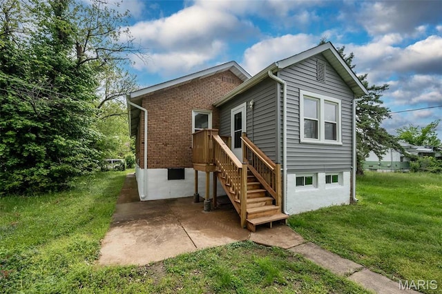 4117 Ravenwood Ave, Saint Louis, MO 63121 - rear view of house featuring a lawn, a patio, and brick siding