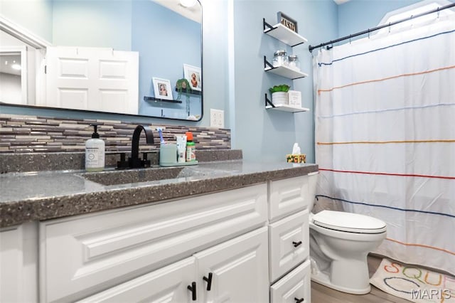 1350 Madison 500, Fredericktown, MO 63645 - full bathroom with tasteful backsplash, vanity, toilet, wood finished floors, and curtained shower