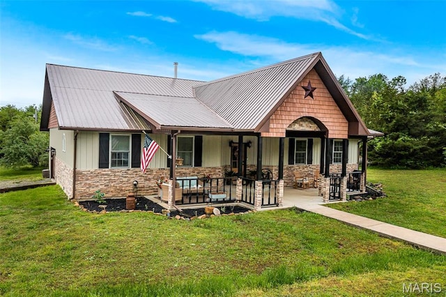 1350 Madison 500, Fredericktown, MO 63645 - view of front of home with stone siding, a front lawn, and metal roof