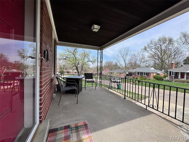view of patio with a balcony and a residential view