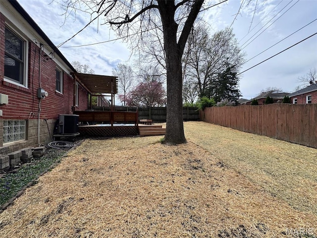 view of yard with a deck and central AC