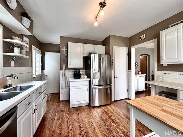 kitchen featuring appliances with stainless steel finishes, light countertops, and white cabinetry