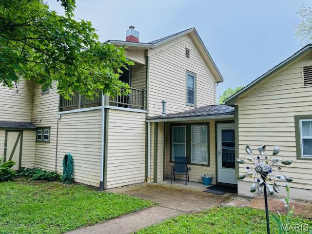 305 Frisco St, Steelville, MO 65565 - rear view of property featuring a chimney, a patio, and a yard