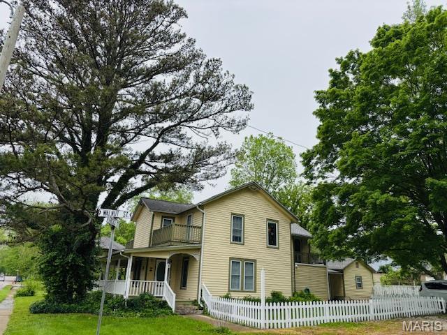 305 Frisco St, Steelville, MO 65565 - traditional-style house with a balcony and covered porch
