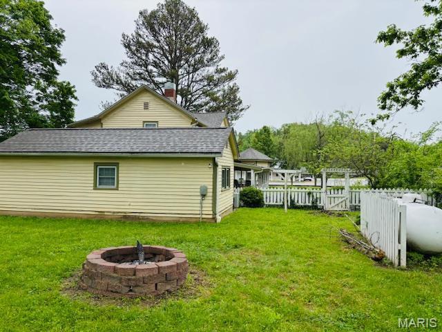 305 Frisco St, Steelville, MO 65565 - back of property with a fire pit and roof with shingles