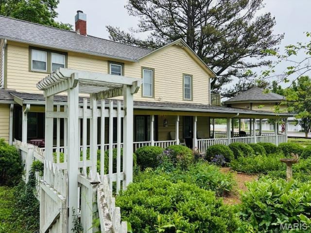 305 Frisco St, Steelville, MO 65565 - rear view of property featuring a sunroom, a chimney, a pergola, and a shingled roof