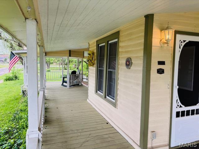 305 Frisco St, Steelville, MO 65565 - wooden deck featuring a porch