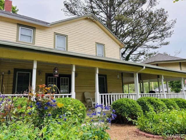 305 Frisco St, Steelville, MO 65565 - farmhouse inspired home with a porch and a chimney