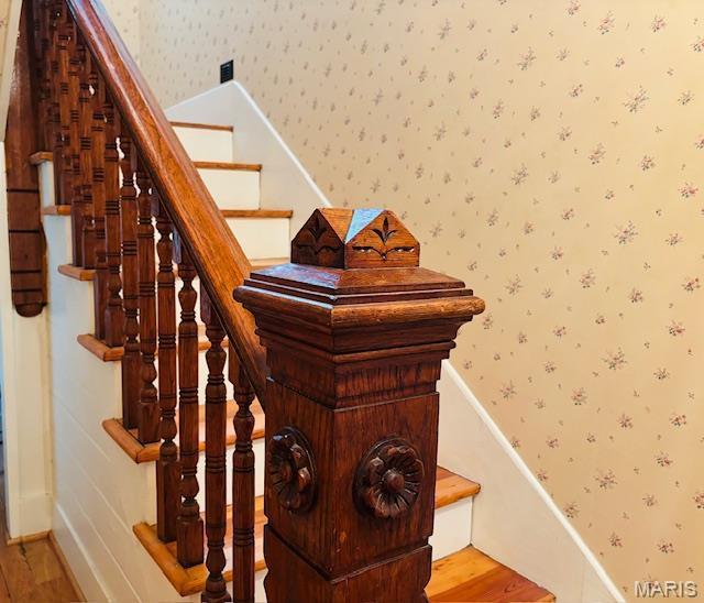 305 Frisco St, Steelville, MO 65565 - staircase featuring wallpapered walls, wood finished floors, and baseboards