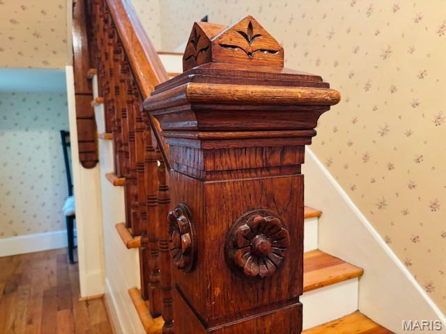 305 Frisco St, Steelville, MO 65565 - stairway featuring wallpapered walls, wood finished floors, and baseboards