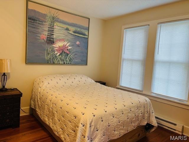 305 Frisco St, Steelville, MO 65565 - bedroom featuring a baseboard heating unit and wood finished floors
