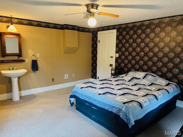 305 Frisco St, Steelville, MO 65565 - carpeted bedroom with wallpapered walls, ceiling fan, baseboards, and a sink