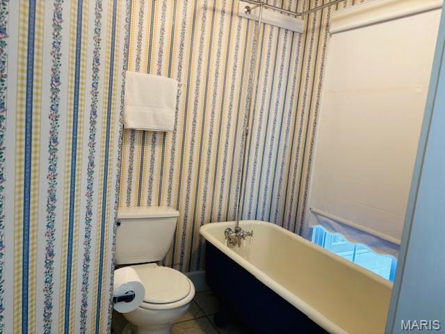 305 Frisco St, Steelville, MO 65565 - bathroom featuring toilet, a freestanding tub, and wallpapered walls