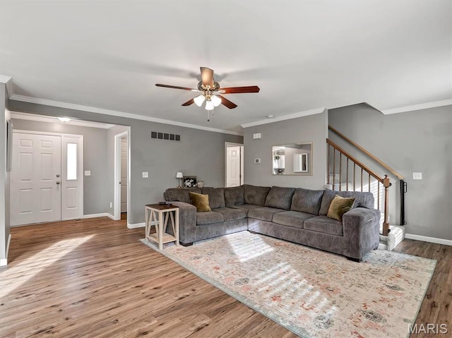 447 Omar Ct, Saint Peters, MO 63376 - living room featuring wood finished floors, ceiling fan, stairway, baseboards, and crown molding