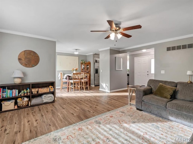 447 Omar Ct, Saint Peters, MO 63376 - living room with ceiling fan, wood finished floors, ornamental molding, and baseboards