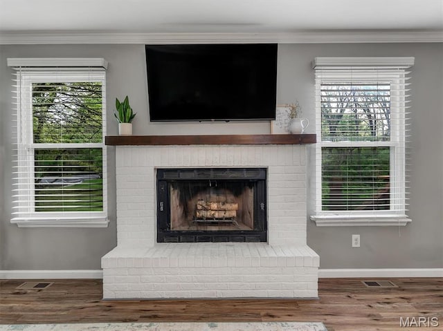447 Omar Ct, Saint Peters, MO 63376 - detailed view of a brick fireplace, ornamental molding, wood finished floors, and baseboards