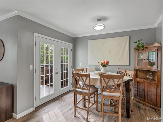 447 Omar Ct, Saint Peters, MO 63376 - dining room with french doors, crown molding, light wood finished floors, and baseboards