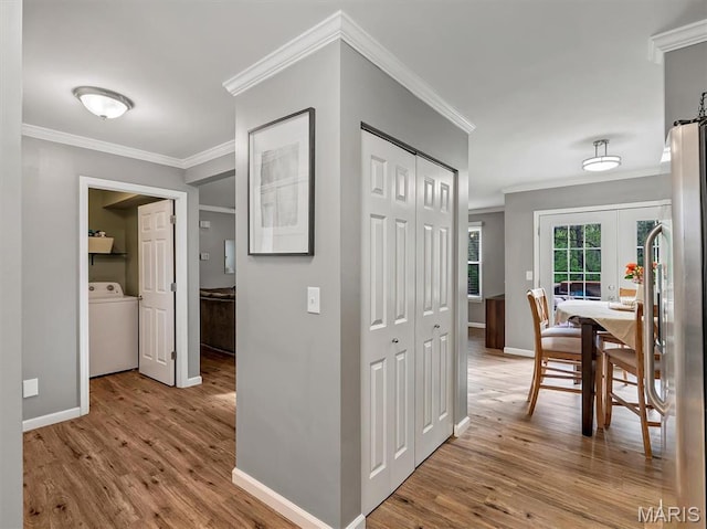 447 Omar Ct, Saint Peters, MO 63376 - hallway with washer / dryer, wood finished floors, ornamental molding, and baseboards
