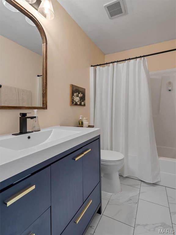 447 Omar Ct, Saint Peters, MO 63376 - bathroom with vanity, marble look tile flooring, toilet, and shower / bath combination with curtain