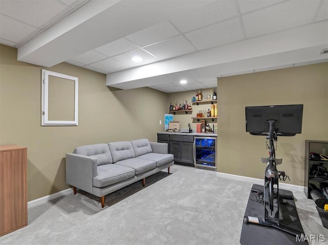 447 Omar Ct, Saint Peters, MO 63376 - living area featuring wine cooler, bar with sink, carpet floors, a drop ceiling, and baseboards