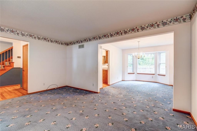 1101 Nathaniel Ct, Hazelwood, MO 63042 - unfurnished room featuring a chandelier, baseboards, carpet floors, and stairway
