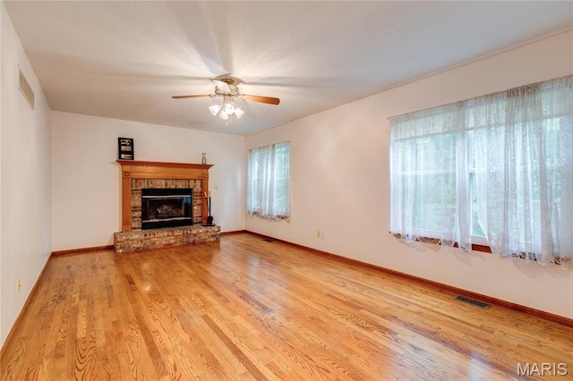 1101 Nathaniel Ct, Hazelwood, MO 63042 - unfurnished living room featuring a ceiling fan, wood finished floors, baseboards, and a fireplace