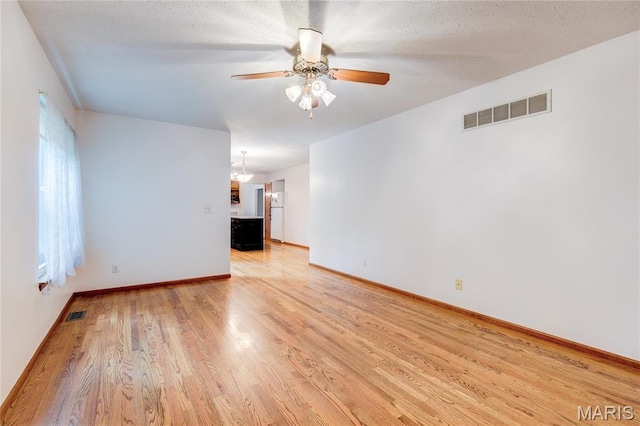 1101 Nathaniel Ct, Hazelwood, MO 63042 - spare room featuring light wood finished floors, ceiling fan, and baseboards
