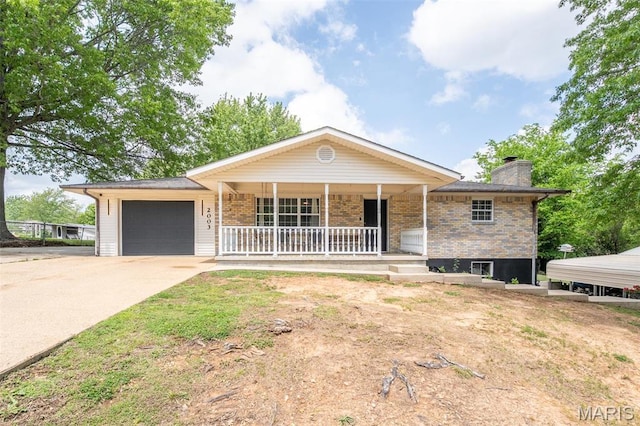2003 Kysar Rd, Poplar Bluff, MO 63901 - single story home featuring covered porch, a garage, concrete driveway, brick siding, and a chimney