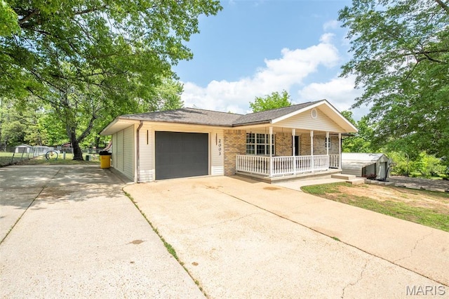2003 Kysar Rd, Poplar Bluff, MO 63901 - ranch-style home featuring covered porch, concrete driveway, a garage, brick siding, and fence