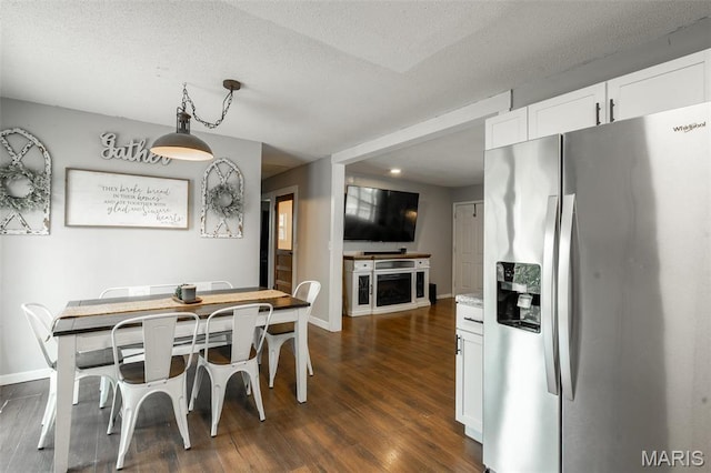 2003 Kysar Rd, Poplar Bluff, MO 63901 - dining space featuring dark wood-style flooring, baseboards, and a textured ceiling