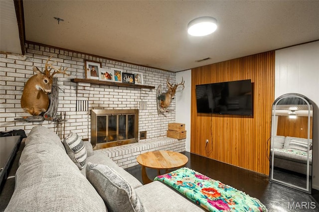 2003 Kysar Rd, Poplar Bluff, MO 63901 - living room featuring a brick fireplace, a textured ceiling, and wood walls