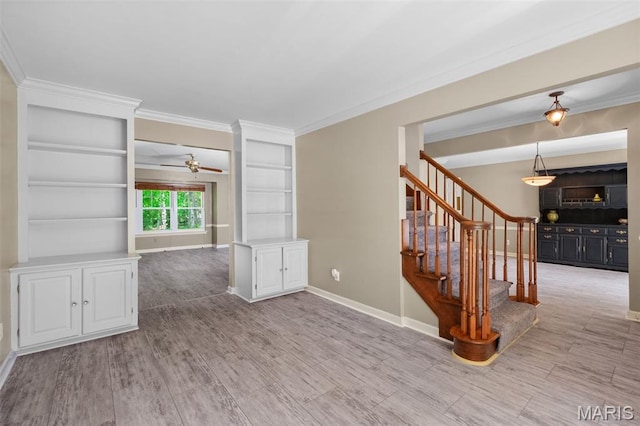 1439 Briarcreek Dr, Saint Louis, MO 63122 - unfurnished room featuring stairs, ornamental molding, ceiling fan, and wood finished floors