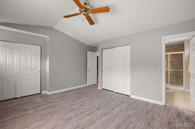 1439 Briarcreek Dr, Saint Louis, MO 63122 - unfurnished bedroom featuring wood finished floors, lofted ceiling, ensuite bath, and a ceiling fan