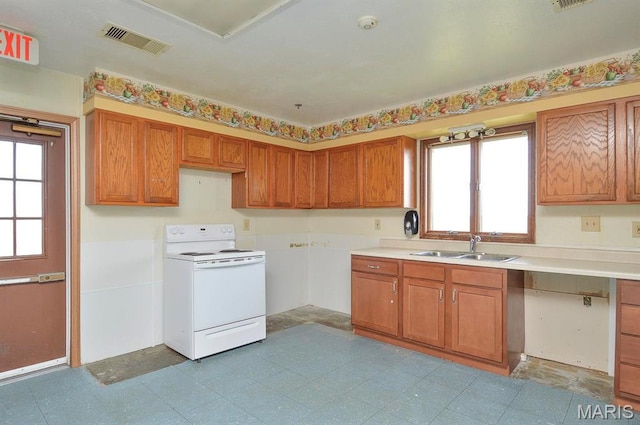 620 N Main St, Hoyleton, IL 62803 - kitchen with white range with electric stovetop, a sink, and brown cabinets
