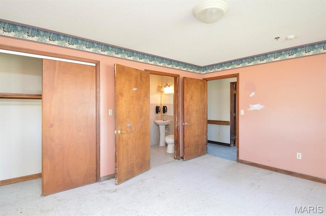 620 N Main St, Hoyleton, IL 62803 - unfurnished bedroom with a closet, baseboards, connected bathroom, and light flooring