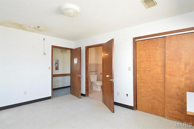 620 N Main St, Hoyleton, IL 62803 - unfurnished bedroom featuring light flooring, baseboards, connected bathroom, and a closet