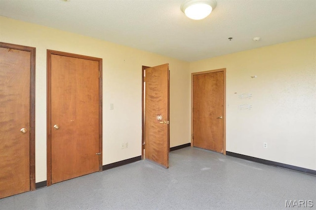 620 N Main St, Hoyleton, IL 62803 - unfurnished bedroom featuring multiple closets and baseboards