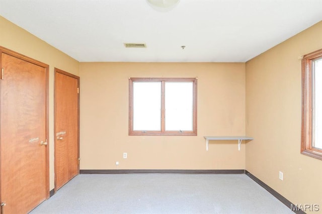 620 N Main St, Hoyleton, IL 62803 - unfurnished bedroom with two closets, baseboards, and light carpet