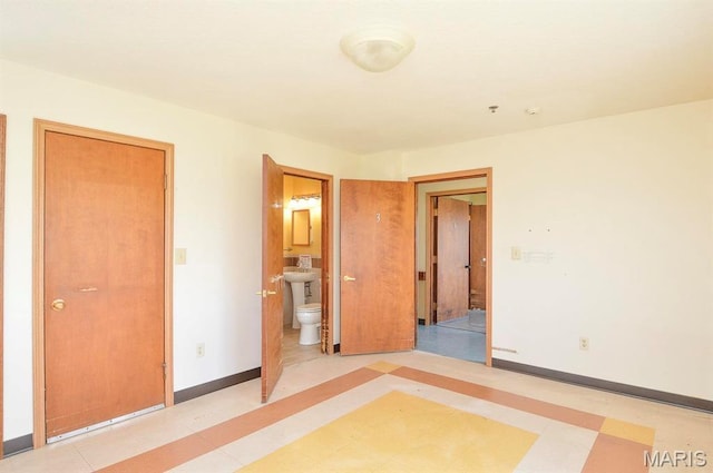 620 N Main St, Hoyleton, IL 62803 - unfurnished bedroom featuring connected bathroom and baseboards