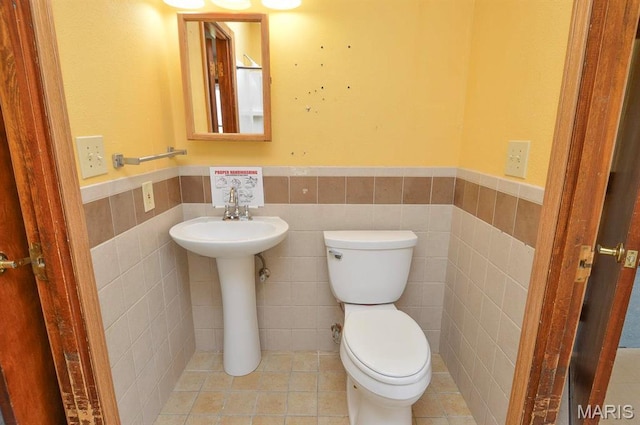 620 N Main St, Hoyleton, IL 62803 - bathroom with a wainscoted wall, toilet, tile walls, and a sink