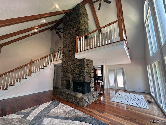 15012 Bay Hills Dr, Dexter, MO 63841 - living area with a ceiling fan, high vaulted ceiling, stairway, hardwood / wood-style floors, and baseboards