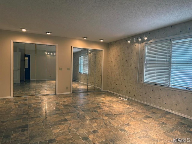 15012 Bay Hills Dr, Dexter, MO 63841 - empty room with baseboards and a textured ceiling