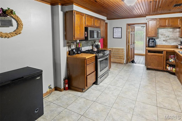 519 N Maple St, Duquoin, IL 62832 - kitchen featuring appliances with stainless steel finishes, wood ceiling, tasteful backsplash, ornamental molding, and light countertops