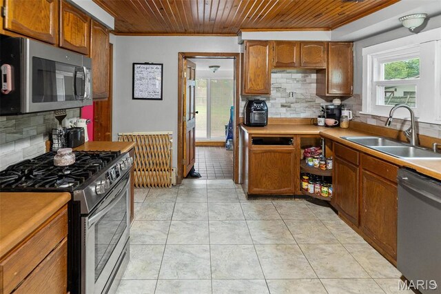 519 N Maple St, Duquoin, IL 62832 - kitchen featuring appliances with stainless steel finishes, a sink, wooden ceiling, crown molding, and decorative backsplash