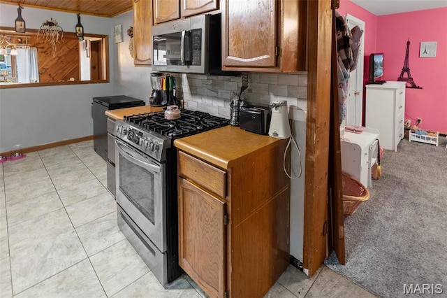 519 N Maple St, Duquoin, IL 62832 - kitchen with stainless steel appliances, decorative backsplash, brown cabinets, baseboards, and wooden ceiling