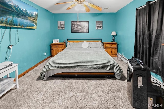 519 N Maple St, Duquoin, IL 62832 - carpeted bedroom featuring a baseboard heating unit, baseboards, and ceiling fan