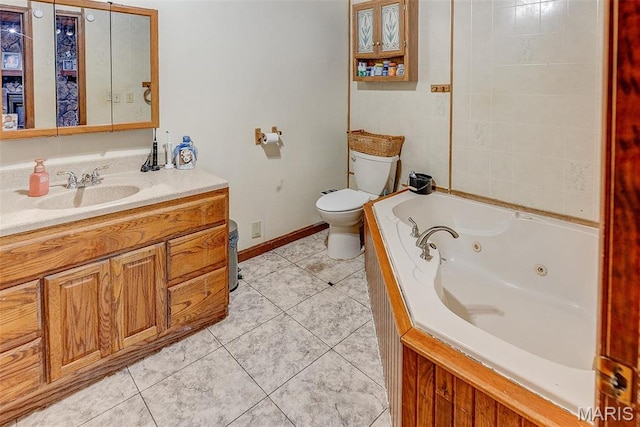 519 N Maple St, Duquoin, IL 62832 - bathroom featuring toilet, a jetted tub, tile patterned flooring, baseboards, and vanity