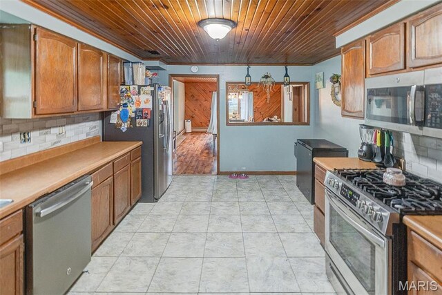 519 N Maple St, Duquoin, IL 62832 - kitchen featuring stainless steel appliances, wood ceiling, tasteful backsplash, brown cabinets, and light countertops
