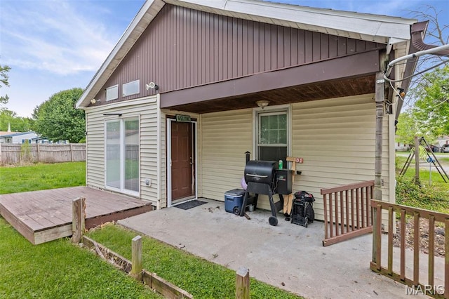 519 N Maple St, Duquoin, IL 62832 - back of house featuring a wooden deck, board and batten siding, and a patio