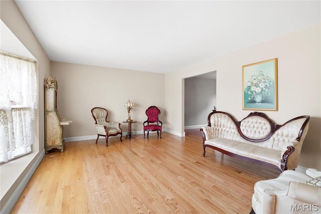 sitting room with light wood-style floors and baseboards